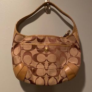 Beige Coach logo canvas hand bag with gold tone hardware.